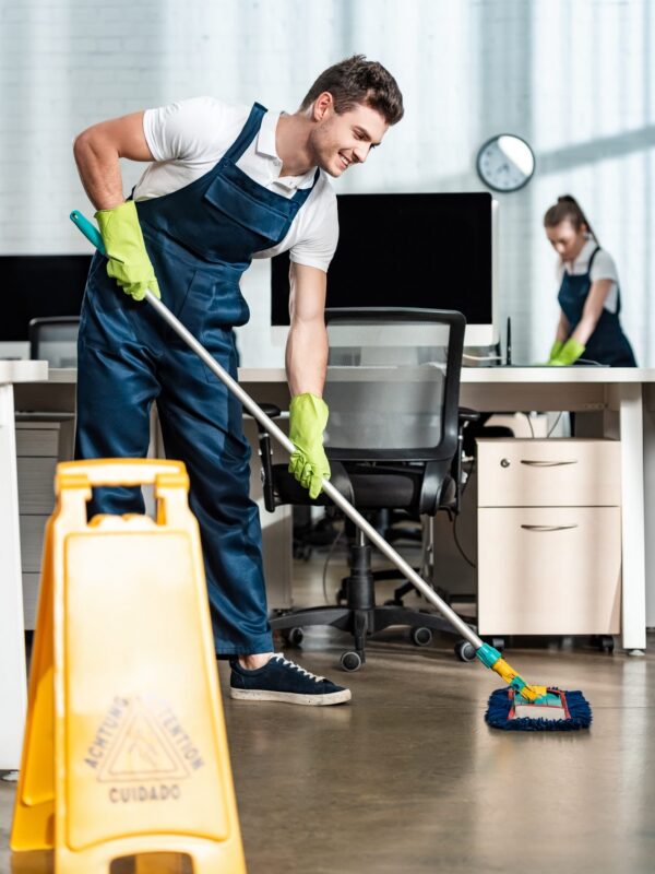 smiling-cleaner-washing-floor-with-mop-near-colleague-cleaning-desk.jpg smiling-cleaner-washing-floor-with-mop-near-colleague-cleaning-desk.jpg